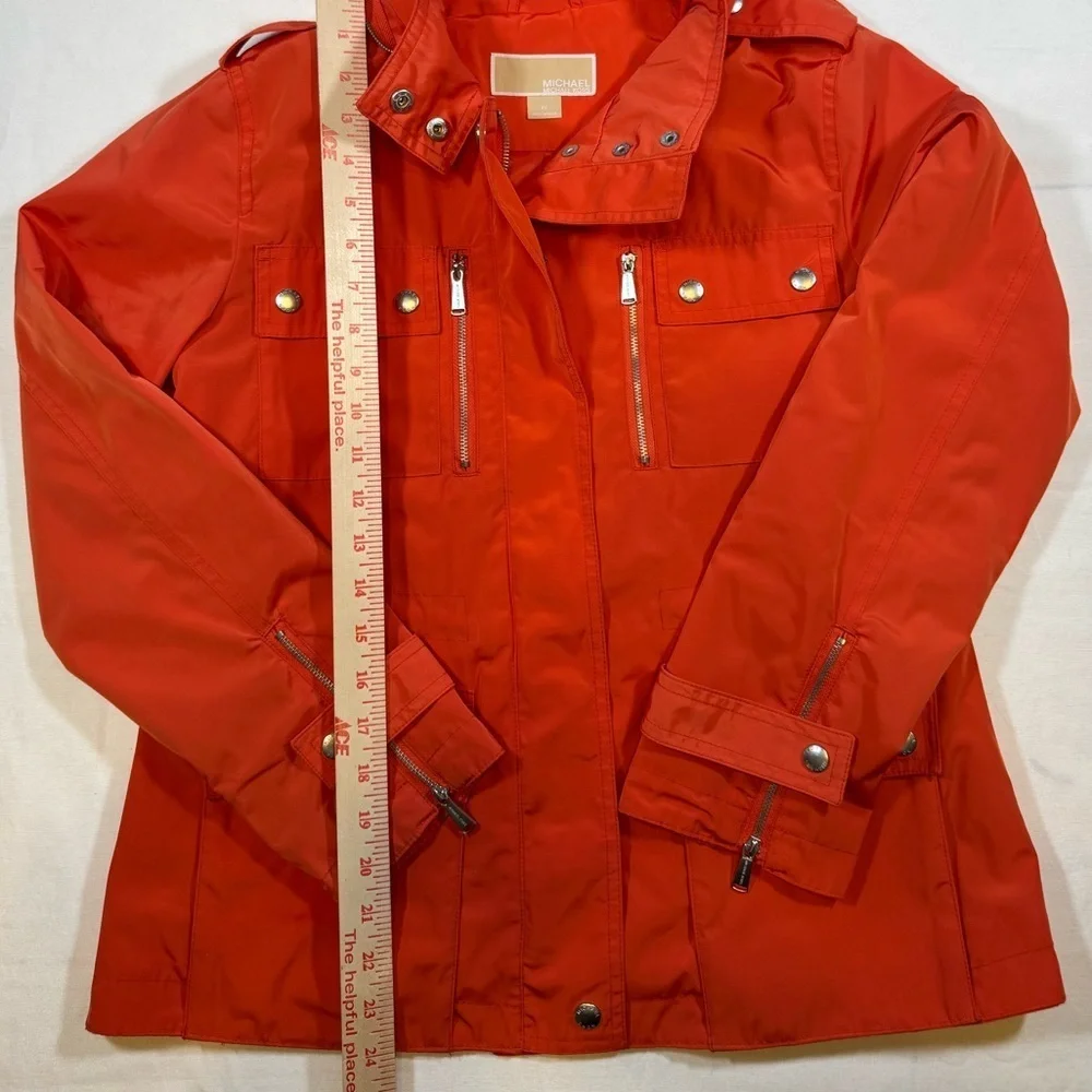NWOT Michael Kor’s Women's Orange Hooded Rain Coat Jacket with silver details